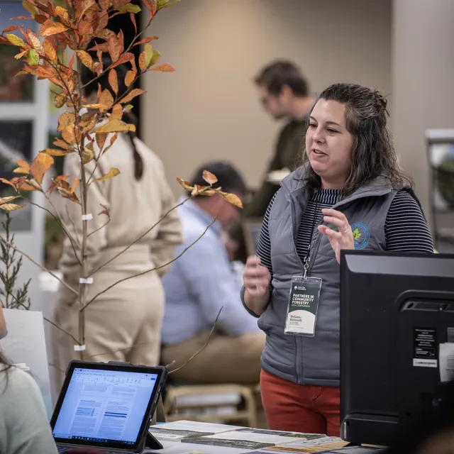 Conference attendee speaking with exhibitor