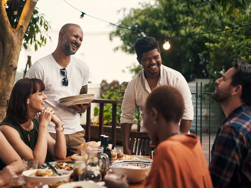 people outside together enjoying a meal