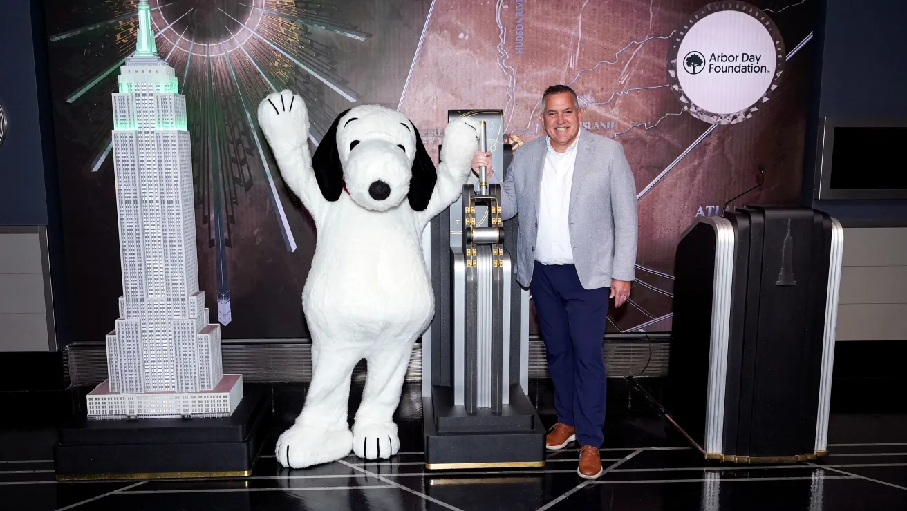 Arbor Day Foundation CEO Dan Lambe and Snoopy at the switch to turn the Empire State Building green.