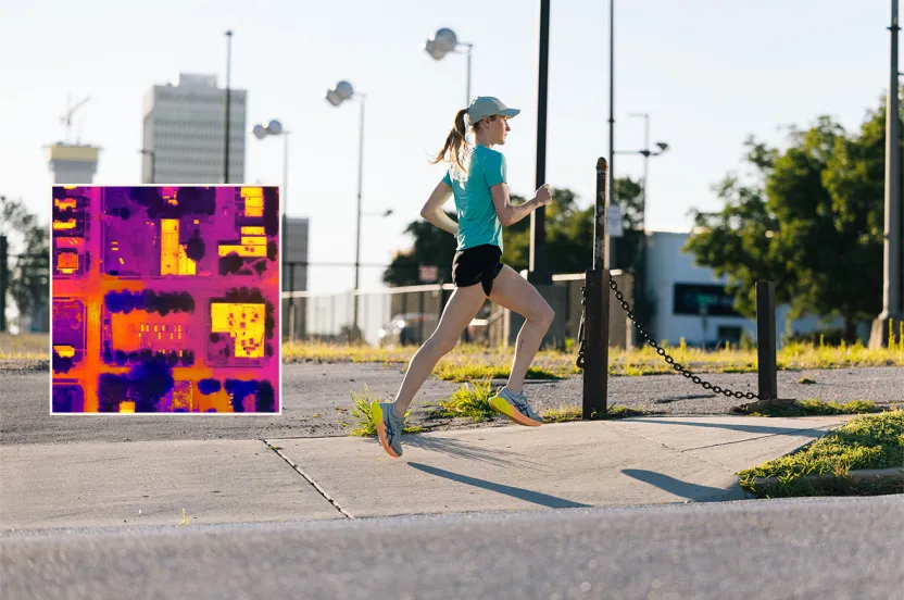 Woman running on urban sidewalk during daytime with inset showing bright thermal aerial view of neighborhood.