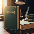 Ordinance book on a desk accompanied by a scale and a lamp, creating a scholarly workspace atmosphere.