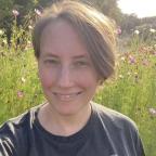 Portrait of Lisa Kelly with wildflowers behind her