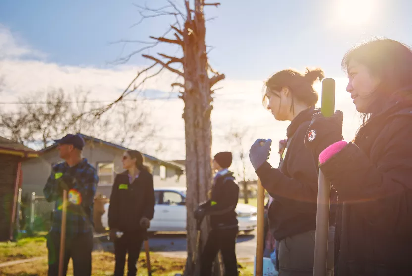 volunteers planting a tree in underserved neighborhood